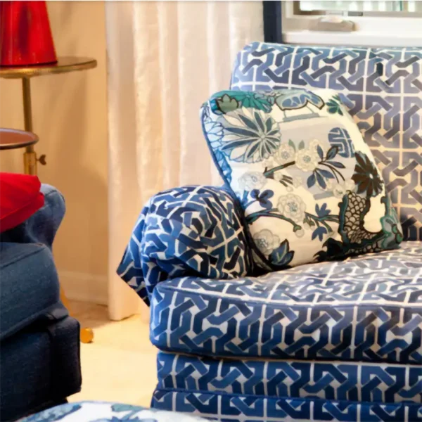 Custom blue geometric upholstered chair with coordinating floral throw pillow by Ash Street Upholstery, Springfield, IL