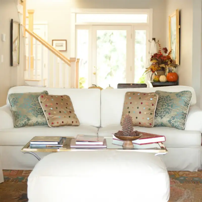Custom white slipcovered sofa with patterned accent pillows by Ash Street Upholstery, serving Springfield, IL