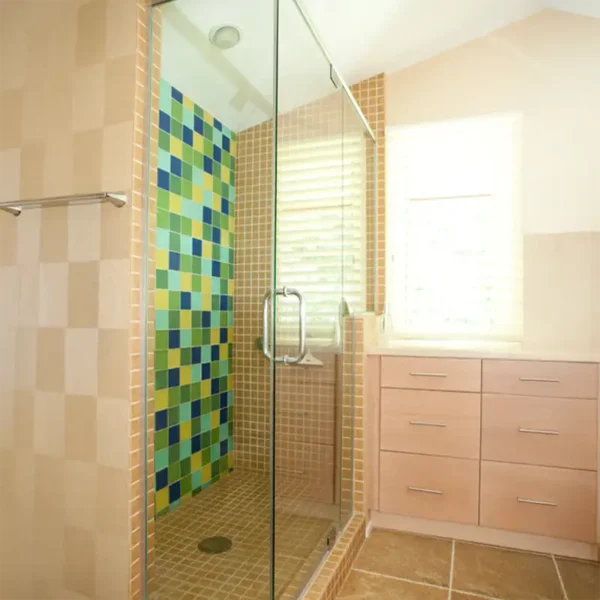 Bathroom renovation interior design by AFAR Imports & Interiors, Springfield, IL, featuring colorful mosaic tile shower