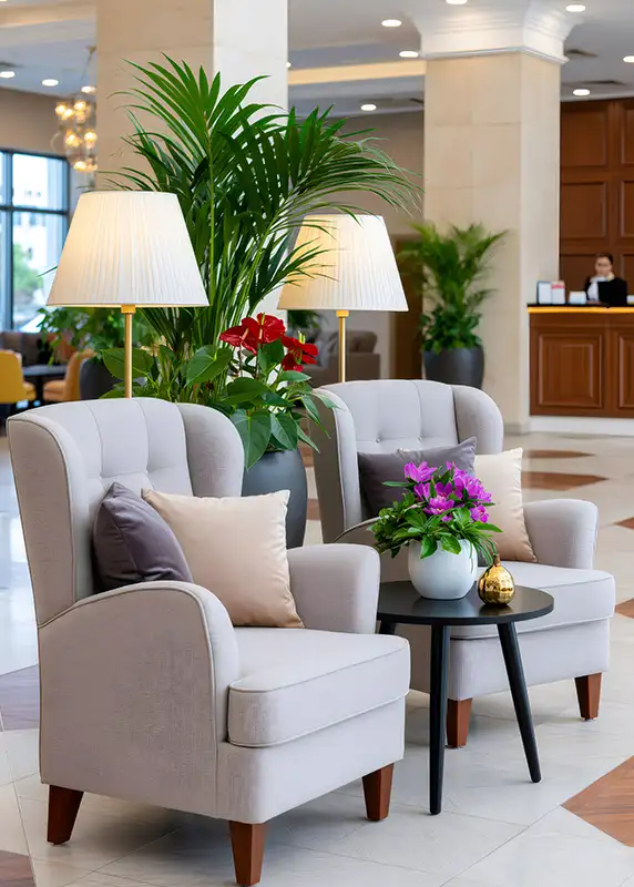 Custom upholstered wingback lounge chairs with modern accents and greenery interior design by AFAR Imports & Interiors for commercial hospitality interiors, Springfield, IL