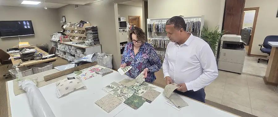 AFAR Imports & Interiors design consultants reviewing fabric swatches with a client in the Springfield, IL showroom
