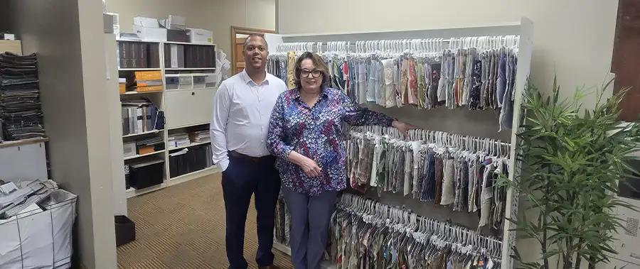 AFAR Imports & Interiors team members beside an extensive fabric library at their Springfield, IL design studio