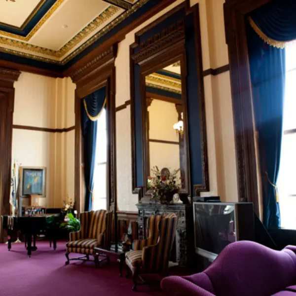 Historic Springfield, IL interior restoration featuring custom draperies and upholstered wingback chairs by AFAR Imports & Interiors
