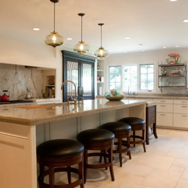 Custom kitchen interior design by AFAR Imports & Interiors, Springfield, IL, featuring marble backsplash and glass pendant lighting