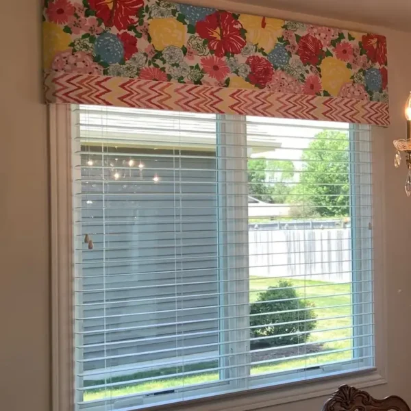 Custom floral drapery panels with woven wood Roman shade, kitchen interior design by AFAR Imports & Interiors, Springfield, IL
