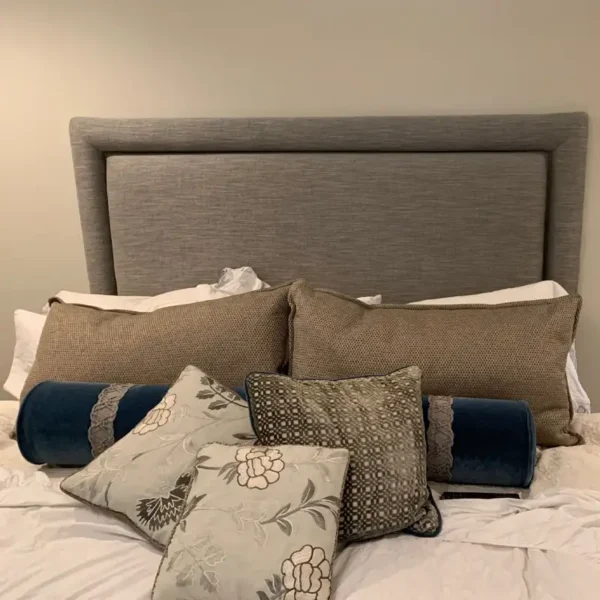 Custom upholstered headboard with decorative pillows by Ash Street Upholstery, Springfield, IL bedroom design