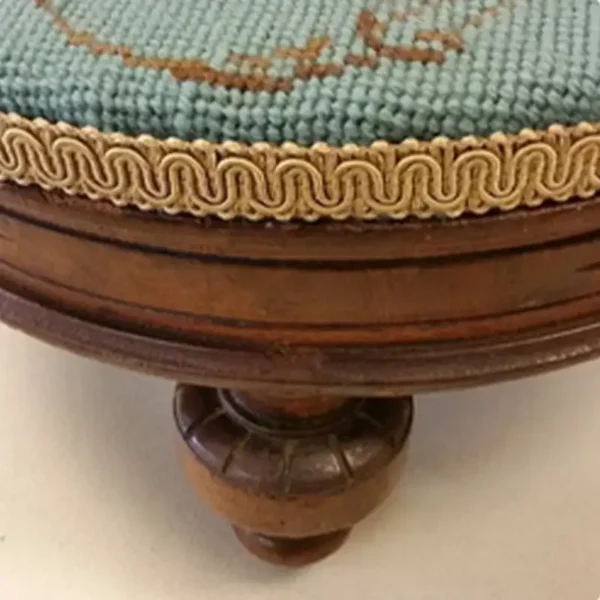 Antique needlepoint footstool with carved wood legs restored by Ash Street Upholstery, Springfield, IL