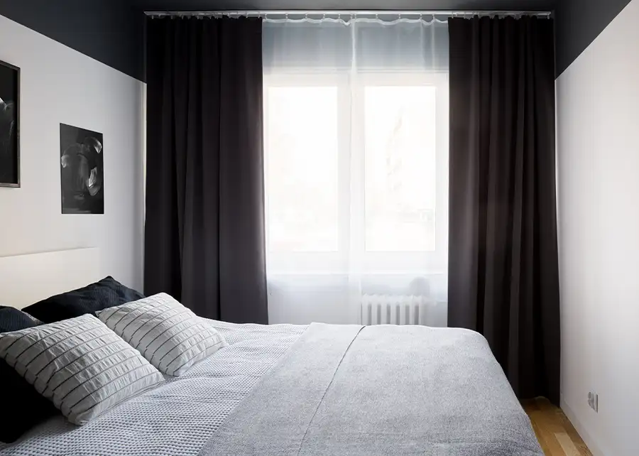 Custom charcoal blackout draperies with sheer accent in modern bedroom by Ash Street Upholstery in Springfield, IL