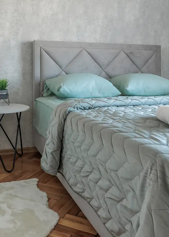 AFAR Imports & Interiors Springfield IL bedroom design featuring a custom upholstered diamond-tufted headboard by Ash Street Upholstery