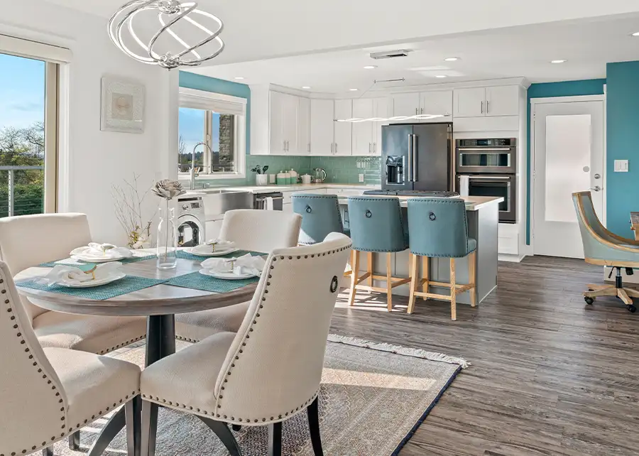Open-concept kitchen and dining interior design in Springfield IL by AFAR Imports & Interiors with custom upholstered barstools and dining chairs from Ash Street Upholstery