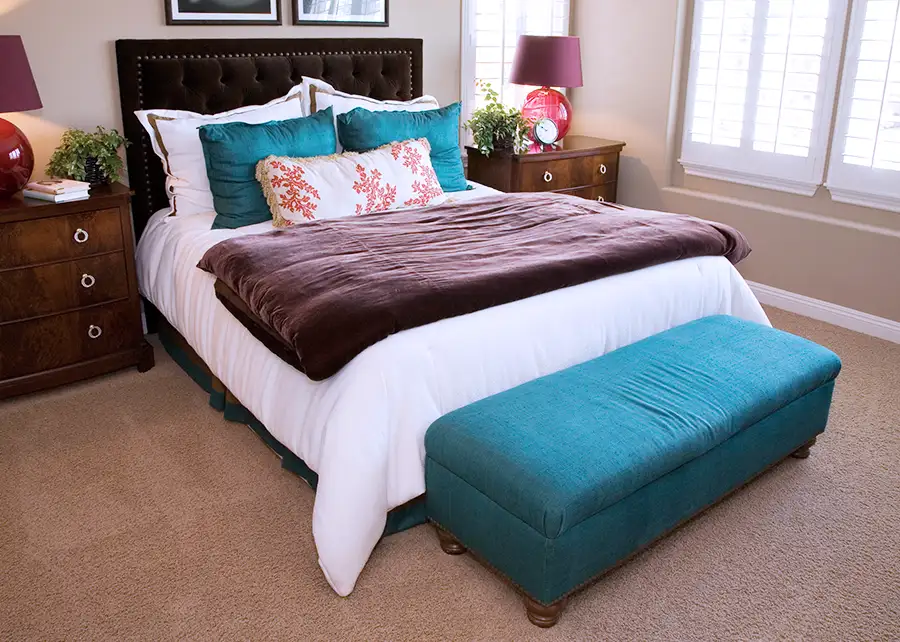 Springfield IL bedroom interior design by AFAR Imports & Interiors featuring a custom upholstered storage bench and tufted headboard by Ash Street Upholstery