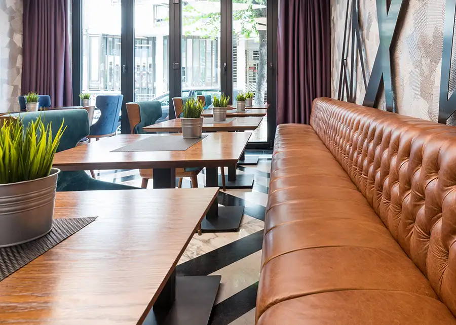 Custom tufted leather banquette seating by Ash Street Upholstery, commercial interior design by AFAR Imports & Interiors in Springfield IL