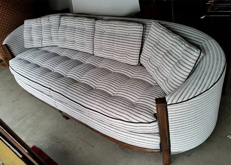 Vintage curved sofa reupholstered in striped fabric by Ash Street Upholstery, Springfield IL's custom furniture restoration and upholstery specialist