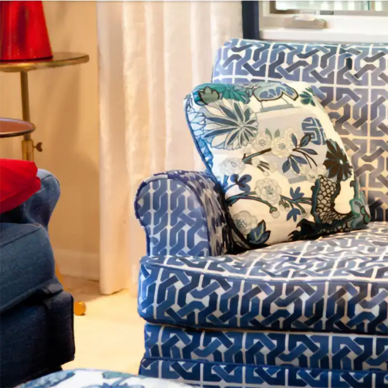Custom blue geometric upholstered chair with coordinating floral throw pillow by Ash Street Upholstery, Springfield, IL
